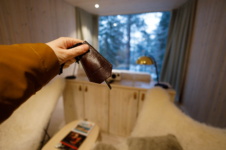 Female hand holding the Key for the arctic Treehouse Hotel Room